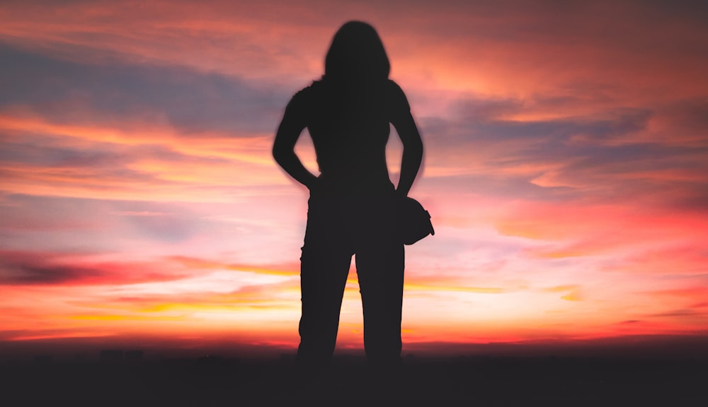 silhouette of person standing during golden hour