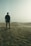 silhouette of man standing on sand