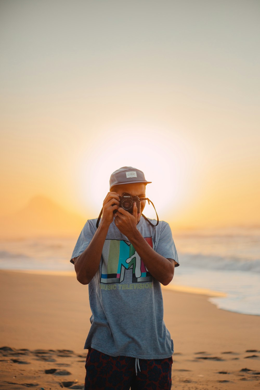 man taking photo on seashore
