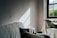 A serene, minimalist living room with soft natural light and organized, harmonious decor.