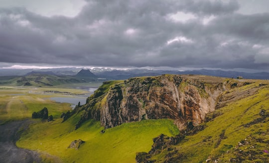 mountain near body of water in Dyrhólaey Iceland