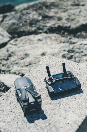 A rugged drone case resting on desert rocks with cacti in the background
