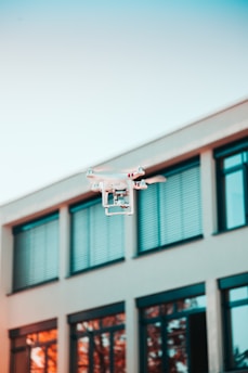 drone flying near building windows for real estate inspection and aerial property assessment