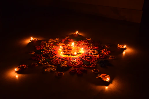 A vibrant rangoli design glowing under soft festival lights.
