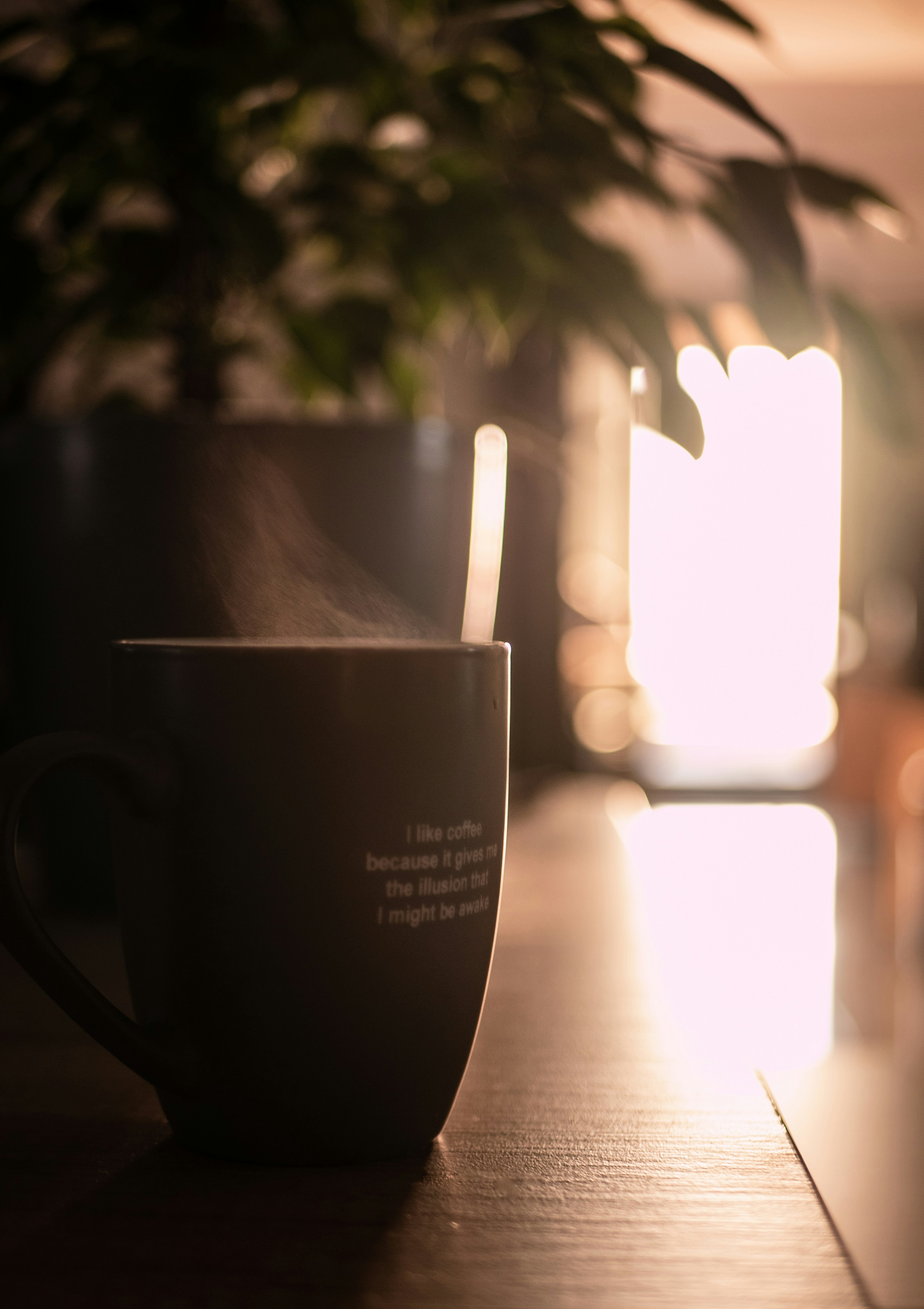 Steaming coffee cup on dark wooden table, moody commercial product photography