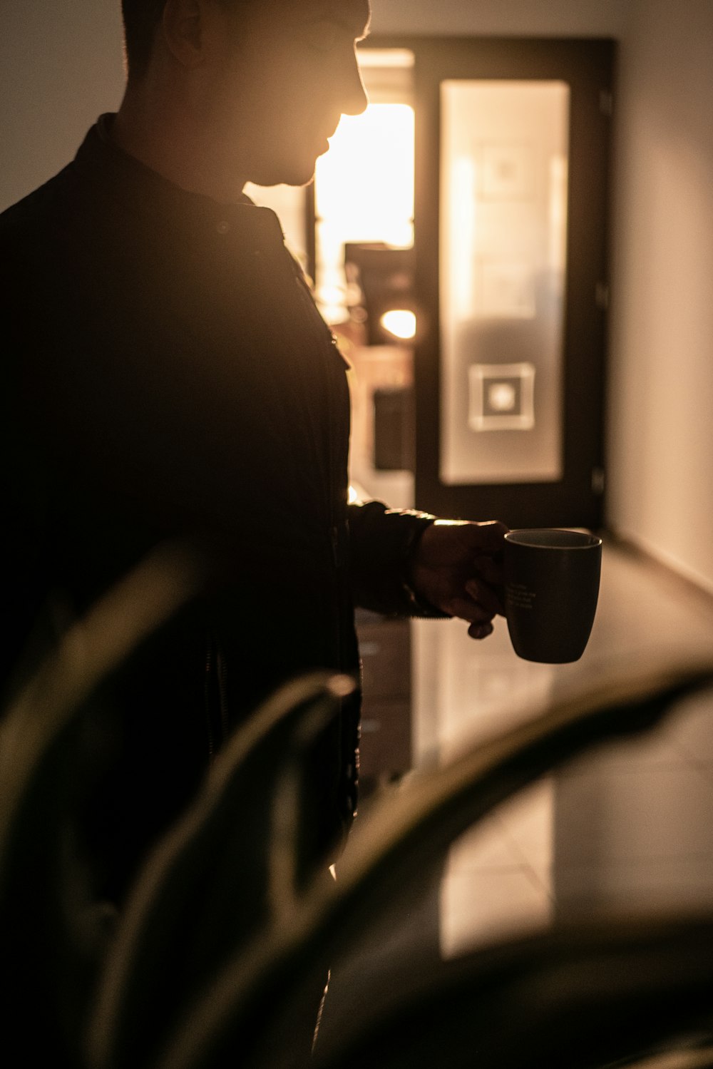 man holding mug inside room