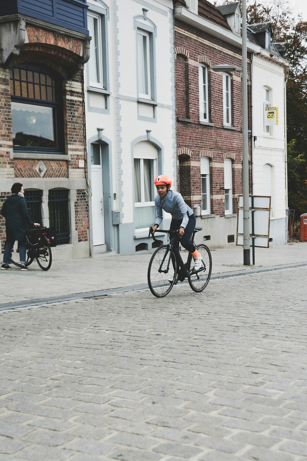 woman riding on bicycle near buldling