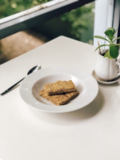 A minimalist, natural-toned setting showcasing cleanbites treats next to a water bowl.