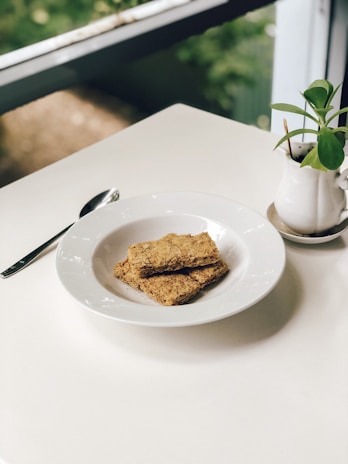 A minimalist, natural-toned setting showcasing cleanbites treats next to a water bowl.
