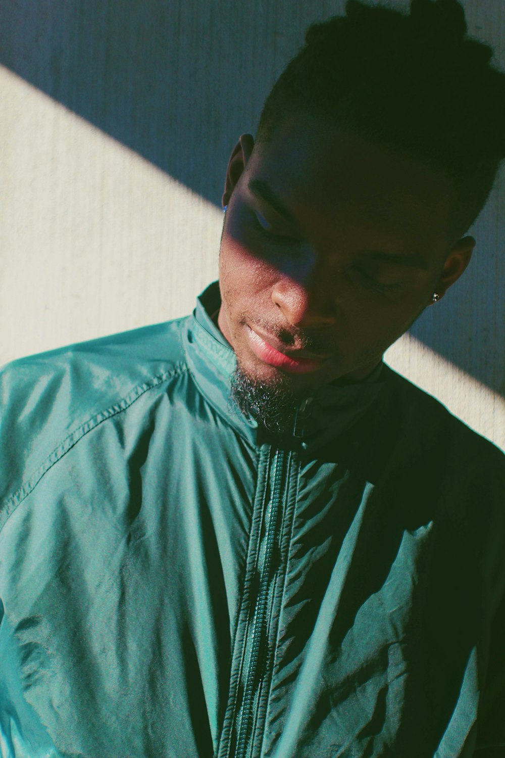 man in green zip-up windbreaker