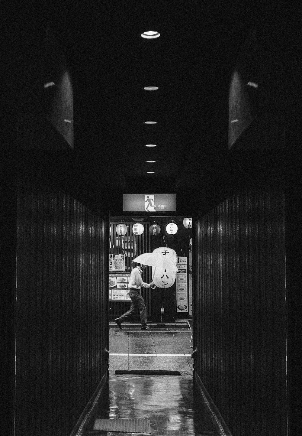 man walking with umbrella at street