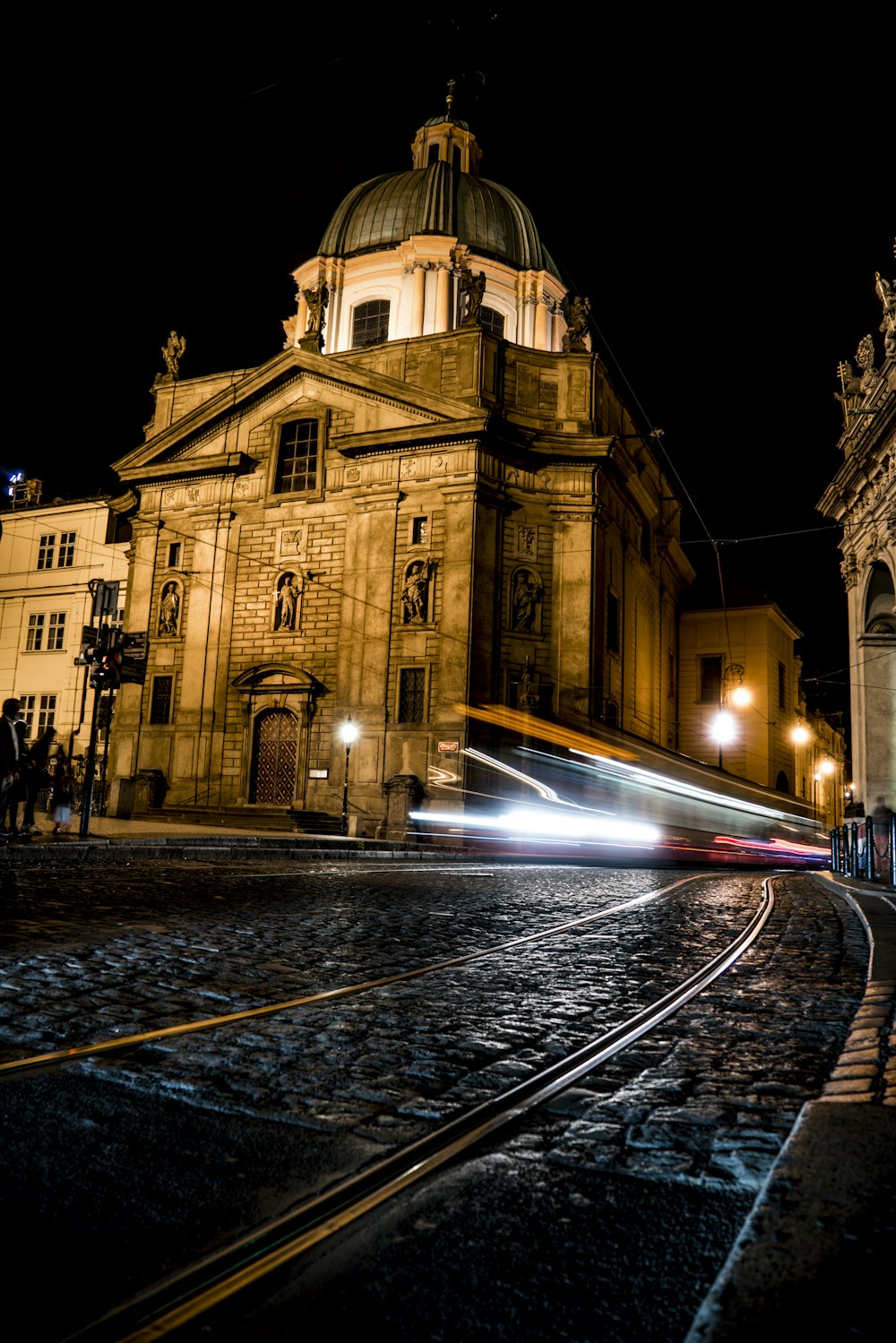 light speed photography of vehicle beside brown concrete structure