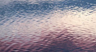 Gentle ripples expanding outward in soft blues and purples.