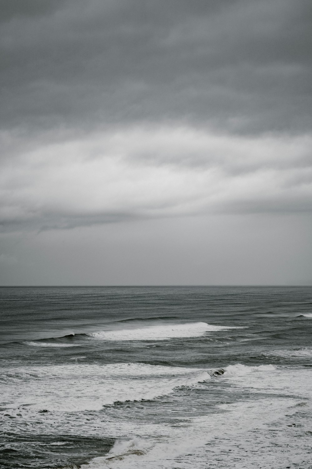 calm water at the sea during cloudy day