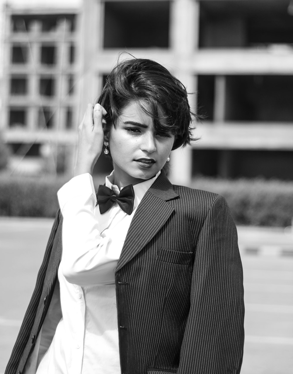 grayscale photography of Lily Collins in suit jacket