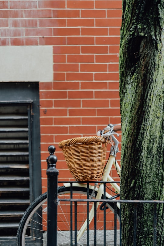 bicycle with woven basket parked beside the street in Boston United States