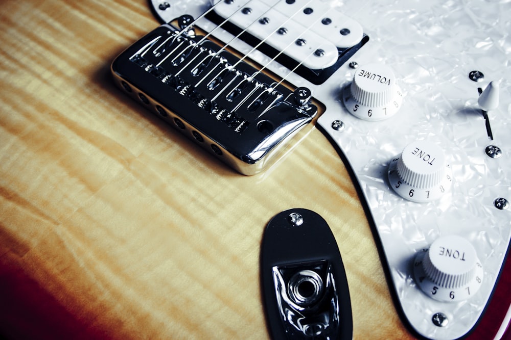 gray and beige electric guitar