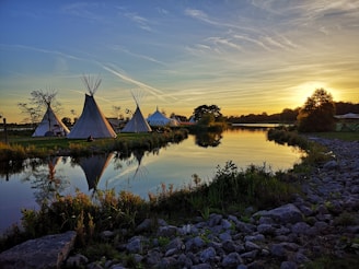 gray tent beside body of water during daytime