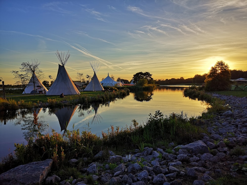 gray tent beside body of water during daytime