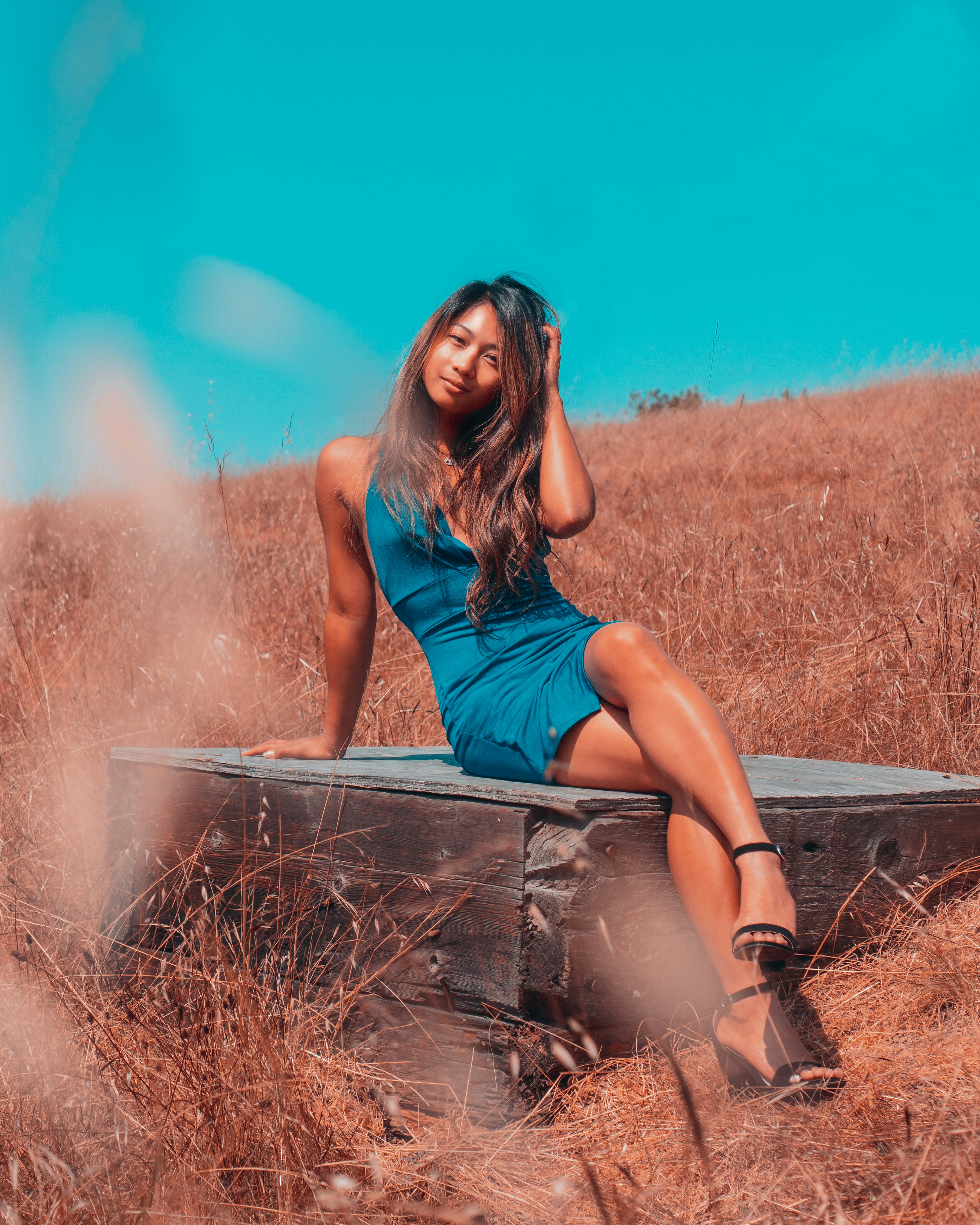 woman sitting on brown wooden bench at daytime