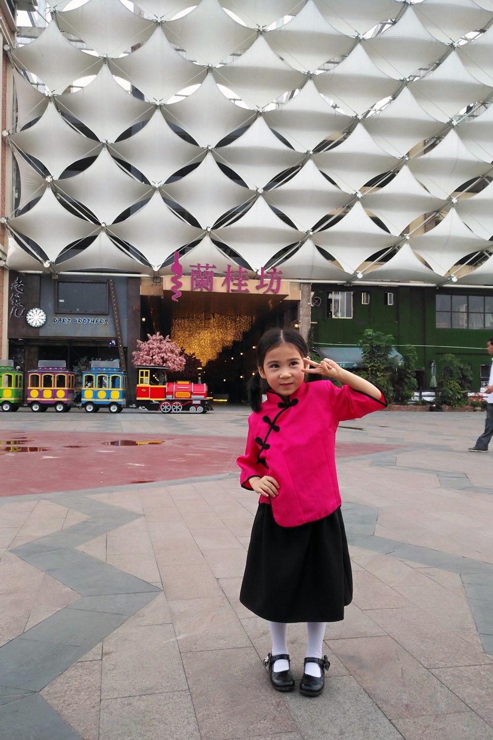 girl doing peace sign near ride on train