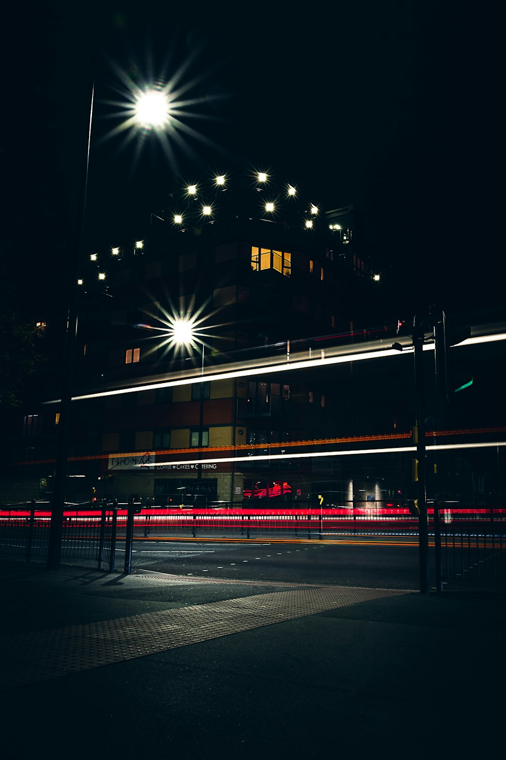 a building lit up at night with street lights