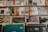 A collection of vinyl records is neatly organized on shelves. The records feature colorful and varied cover art, showcasing different music genres such as soul, funk, and hip hop. The record sleeves are arranged in rows, with some covers displaying artwork and text that are prominent and visually engaging.