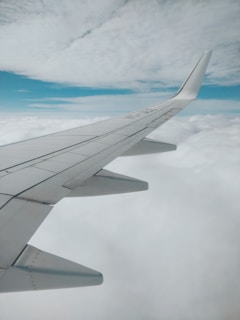 aerial photography of airplane wing and clouds