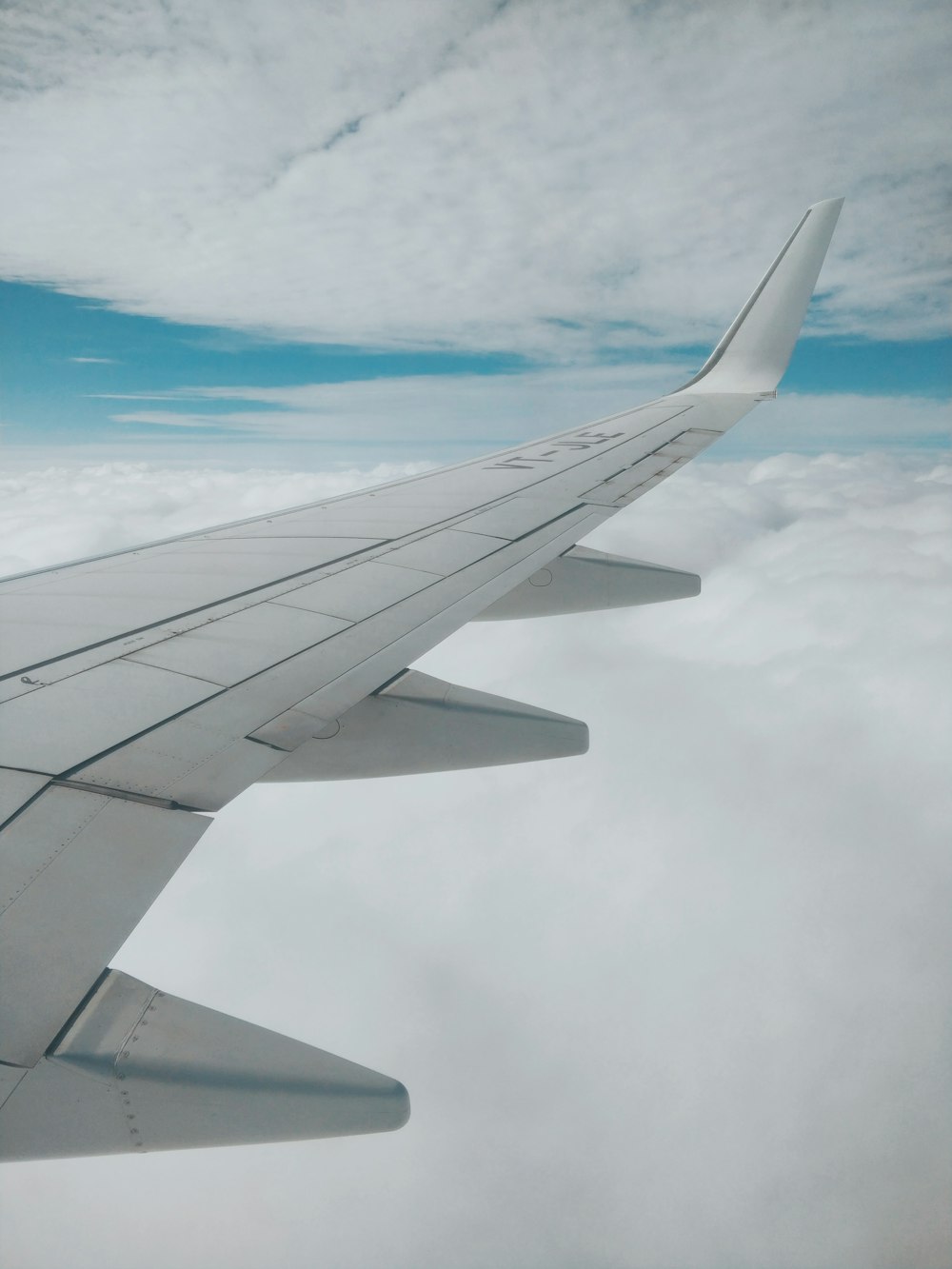 aerial photography of airplane wing and clouds
