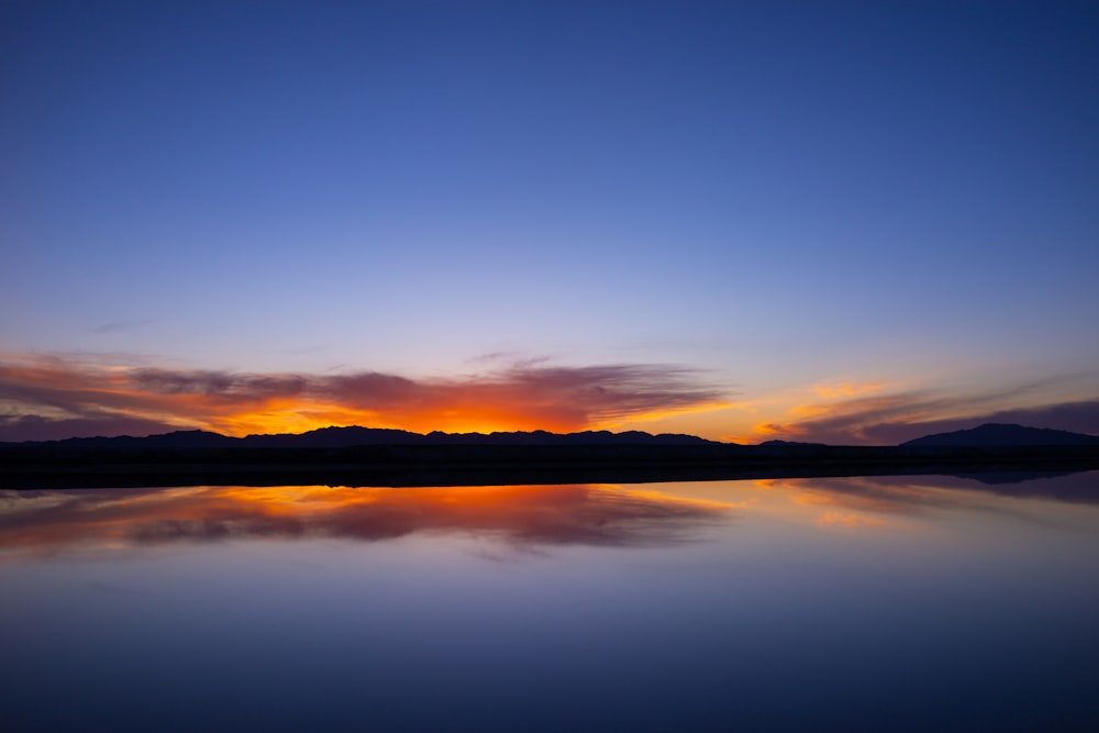 silhouette of mountain under clear blue sky