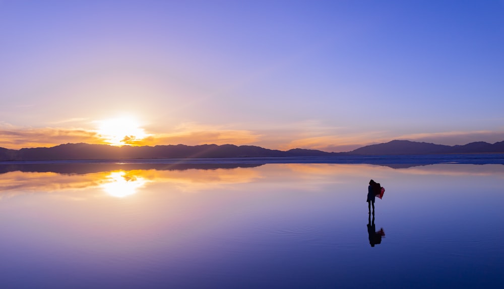 silhouette of person across horizon