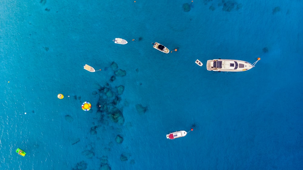 a group of boats floating on top of a blue ocean