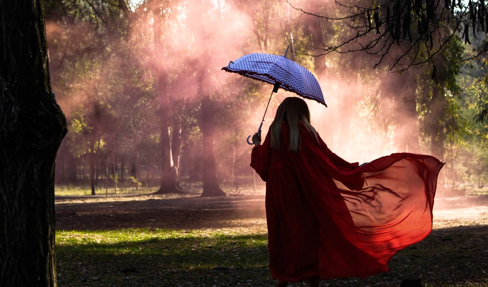 woman holding blue umbrella