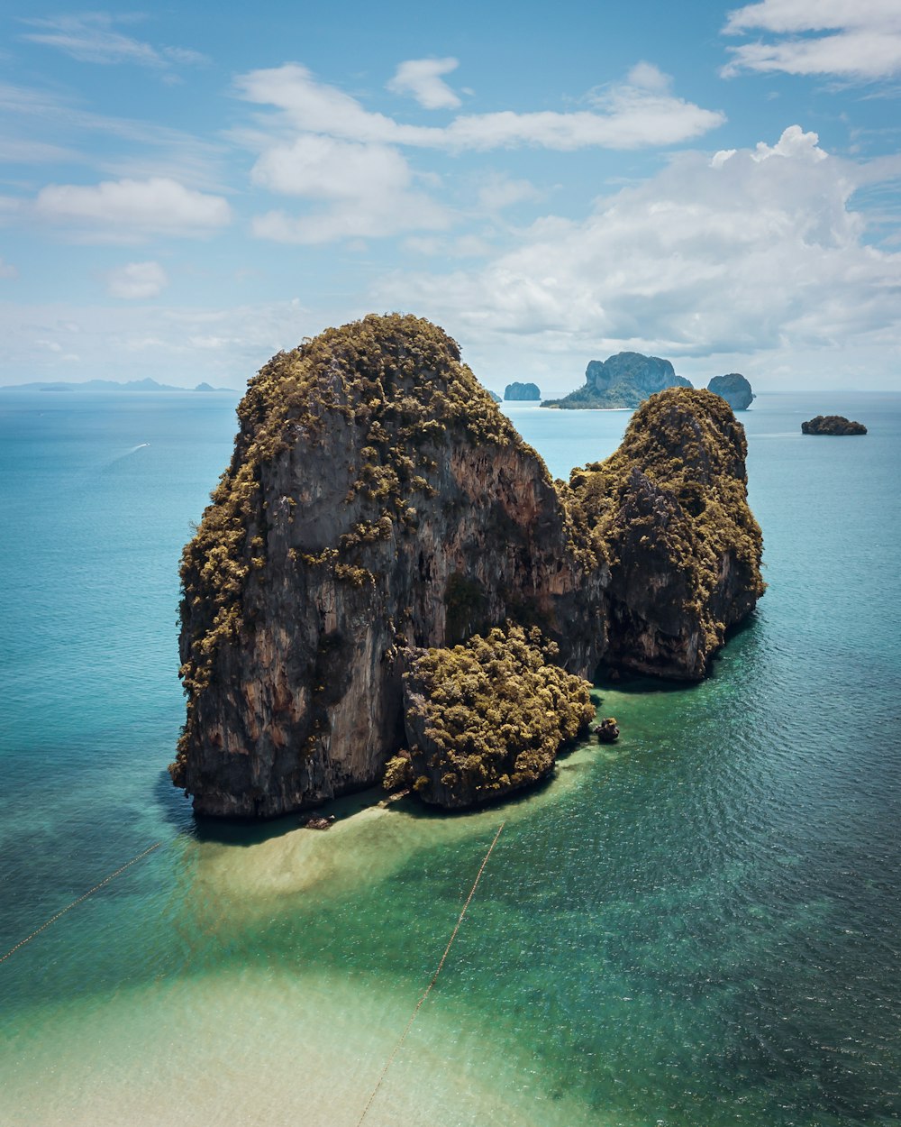 a couple of large rocks sitting in the middle of a body of water