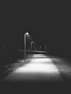 A vibrant solar street light illuminating a pathway at night.