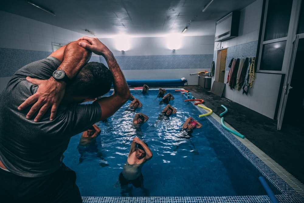 people stretching inside pool room