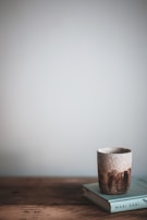 Japanese wabi-sabi style ceramic cups with subtle imperfections, resting on a bamboo mat.