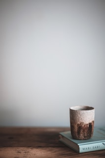 Japanese wabi-sabi style ceramic cups with subtle imperfections, resting on a bamboo mat.