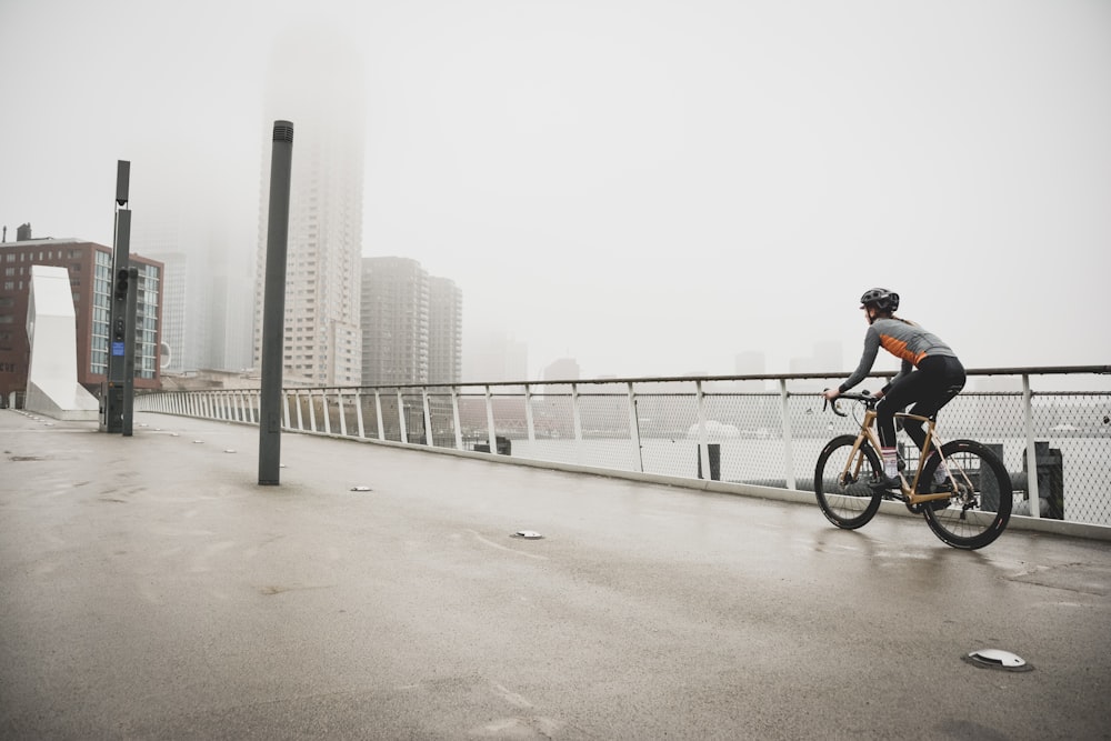 person riding bicycle on road during daytime