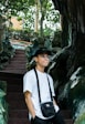 man standing beside tree on focus photography