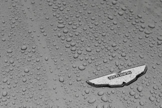 Close-up macro shot of a ceramic coating bead glistening on a polished car surface.