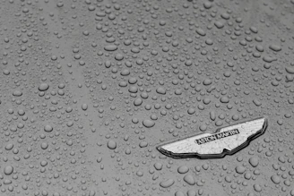 Close-up of water beading on a car surface protected by ceramic coating.