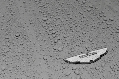 Close-up of water beading on a car surface protected by ceramic coating.