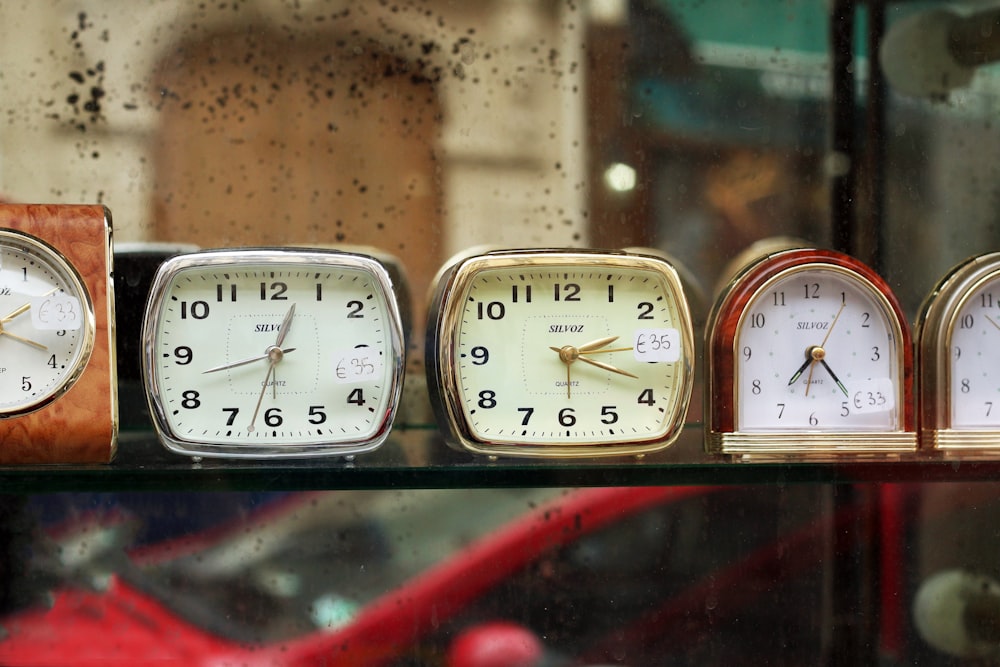 assorted-color analog clocks during daytime photo