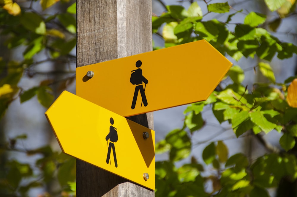 yellow road signage at daytime