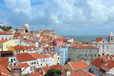 concrete houses beside calm water at daytime portugal google meet background