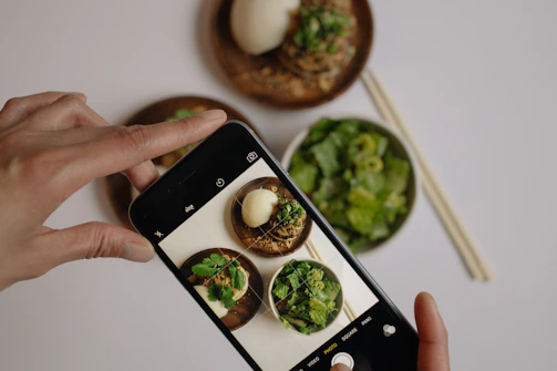 A user scanning a colorful meal with a smartphone using nutrivista's AI-powered food recognition.