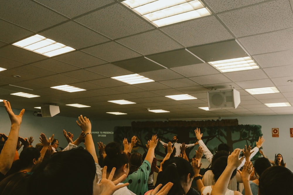 people hand up inside room