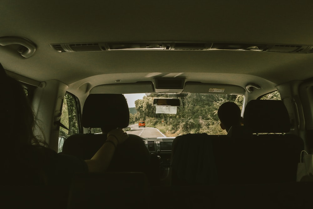 person sitting on vehicle seat inside vehicle