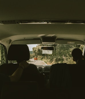 person sitting on vehicle seat inside vehicle